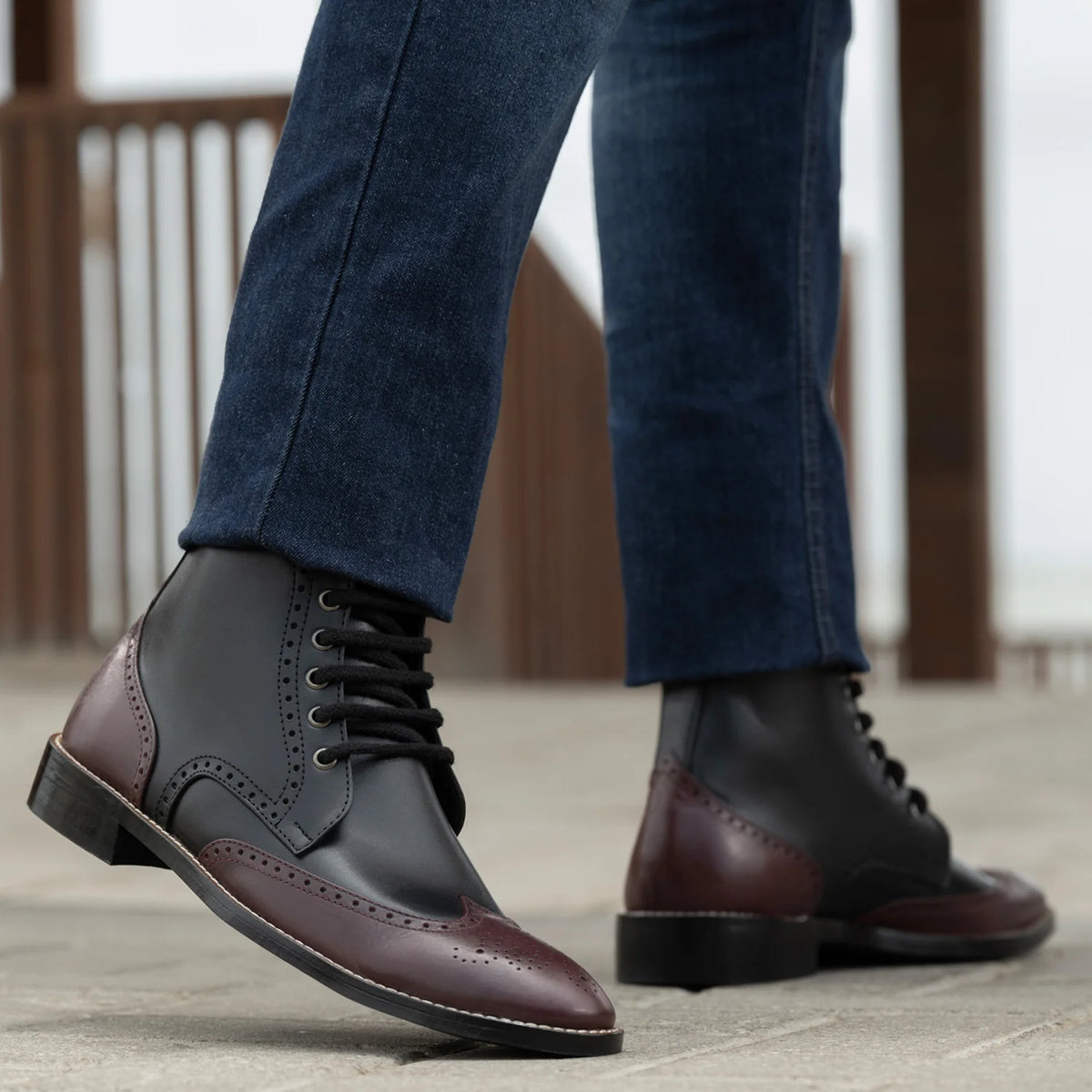 Perspectiva del modelo vistiendo Duster Brogues Derby Maroon Black Leather Boots StudGuard For Men en modelo con caída natural bajo luz de día